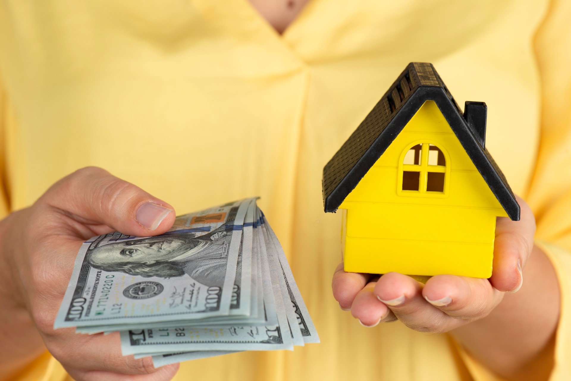 Woman Holding Dollars And Model House